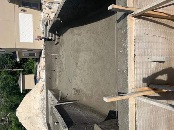 Top-down construction view of the main concrete pool casing and structural stairs